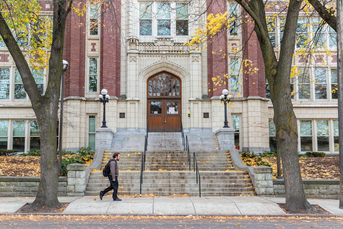 A man walks by Lewis and Clark High School on Nov. 4, 2018. A threat was made against the school on Instagram Saturday night and is under investigation by police. (Libby Kamrowski / The Spokesman-Review)