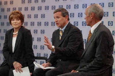 
Hewlett-Packard Co. new president and CEO Mark Hurd, center, gestures as he sits next to Patricia Dunn, left, HP's non-executive chairman, and Robert Wayman, right, HP's CFO. 
 (Associated Press / The Spokesman-Review)