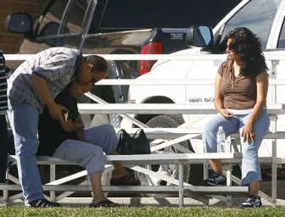 Friends and family members of trapped miners wait outside Canyon View Junior High School in Huntington, Utah, on Monday. Associated Press
(Associated Press / The Spokesman-Review)
