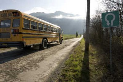 
The early morning sun rises over Thompson Ridge on April 29 as a school bus carries students to the Mormon Hills School. The school  broke off from Bountiful Elementary-Secondary School due to a conflict in the community. Associated Press photos
 (Associated Press photos / The Spokesman-Review)