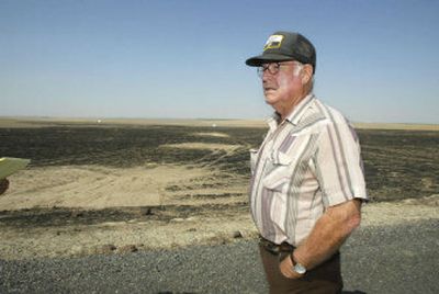 
Wheat farmer Arnold Hudlow stands near the site where his grandson  discovered pieces of a human skull on Aug. 12 while picking up trash from property they manage along Dyck Road about  10 miles north of Connell, Wash. Hudlow said a brush fire in July apparently uncovered the human bones. 
 (Bob Brawdy Tri-City Herald / The Spokesman-Review)
