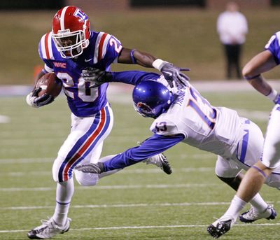 Louisiana Tech’s Daniel Porter tries to elude Brandyn Thompson of Boise State.  (Associated Press / The Spokesman-Review)