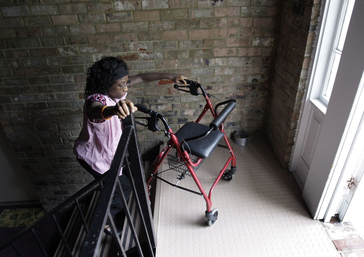 Shalonda Frederick navigates the stairs at her apartment in Glen Burnie, Md., this month.  Associated Press photos (Associated Press photos / The Spokesman-Review)