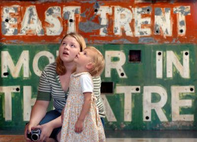 
Framed by an old drive-in theater sign, Olivia Klingbeil, left and her cousin Vanessa Steenhuis, 2 , gaze into a case of antique dolls at the Spokane Valley Heritage Museum. 
 (INGRID BARRENTINE / The Spokesman-Review)