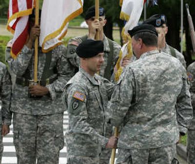 
Lt. Gen. Charles H. Jacoby, center, receives flags that symbolize his command from Gen. Charles C. Campbell,  the commanding general of U.S. Army Forces Command, during an assumption of command ceremony Monday at Fort Lewis, Wash. Jacoby  took over from Brig. Gen. William Troy,  who was  interim commander. Associated Press
 (Associated Press / The Spokesman-Review)