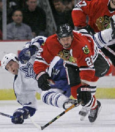 
 Chicago's Martin Lapointe, right, and Toronto's Bryan McCabe collide. 
 (Associated Press / The Spokesman-Review)