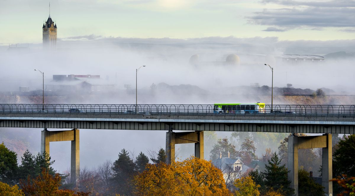 A Spokane Transit Authority bus travels north on the Maple Street Bridge as a bank of fog engulfs the Spokane River gorge, leaving the top of the Spokane County Courthouse exposed on Oct. 22, 2012.  (DAN PELLE/THE SPOKESMAN-REVIEW PHOTO ARCHIVE)