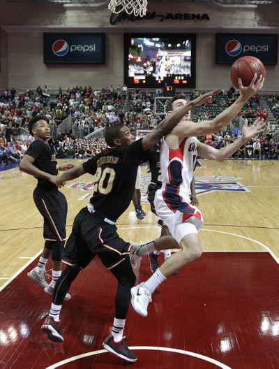 Gonzaga's David Stockton, right, puts up the winning shot with 1.4 seconds left on the clock against Santa Clara's Denzel Johnson in the second half of a quarterfinal West Coast Conference NCAA college basketball tournament game on Saturday, March 8, 2014, in Las Vegas. Gonzaga won 77-75. (Julie Jacobson / Associated Press)