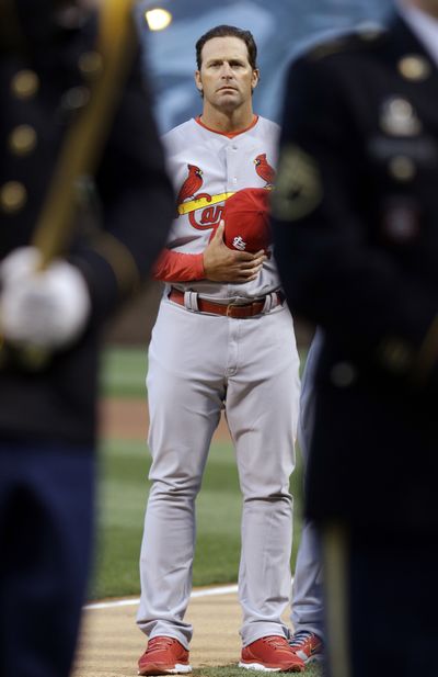 Cards manager Mike Matheny listens to national anthem. (Associated Press)