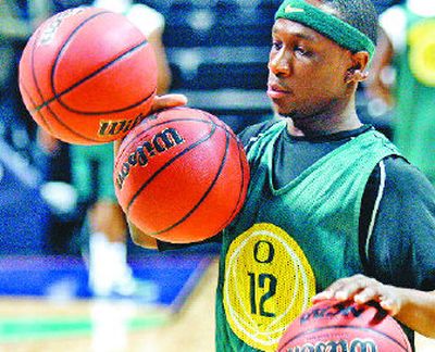 
Oregon's Tajuan Porter dribbles three basketballs during practice Thursday. 
 (Associated Press / The Spokesman-Review)