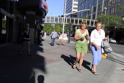 Shoppers walk through downtown Spokane on Thursday.  (Jesse Tinsley / The Spokesman-Review)