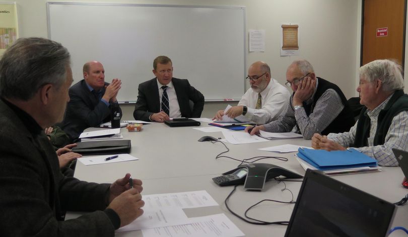 From left, Idaho state tax commissioners Tom Katsilometes, Elliot Werk and Ken Roberts hear from economists Don Holley and Don Reading on forecasts for personal income in Idaho next year, during their annual Economic Estimates Commission meeting on Thursday, Nov. 30, 2017. The commission is charged with issuing a formal estimate of personal income for use in capping state spending. One current candidate for Idaho governor, Tommy Ahlquist, wants the current spending cap process strengthened. (Betsy Z. Russell / SR)