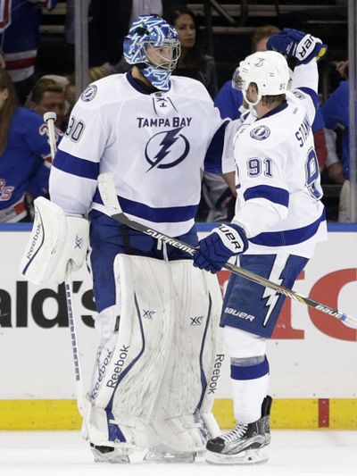 Lightning center Steven Stamkos, right, congratulates goalie Ben Bishop after Bishop posted a shutout against the Rangers. (Associated Press)