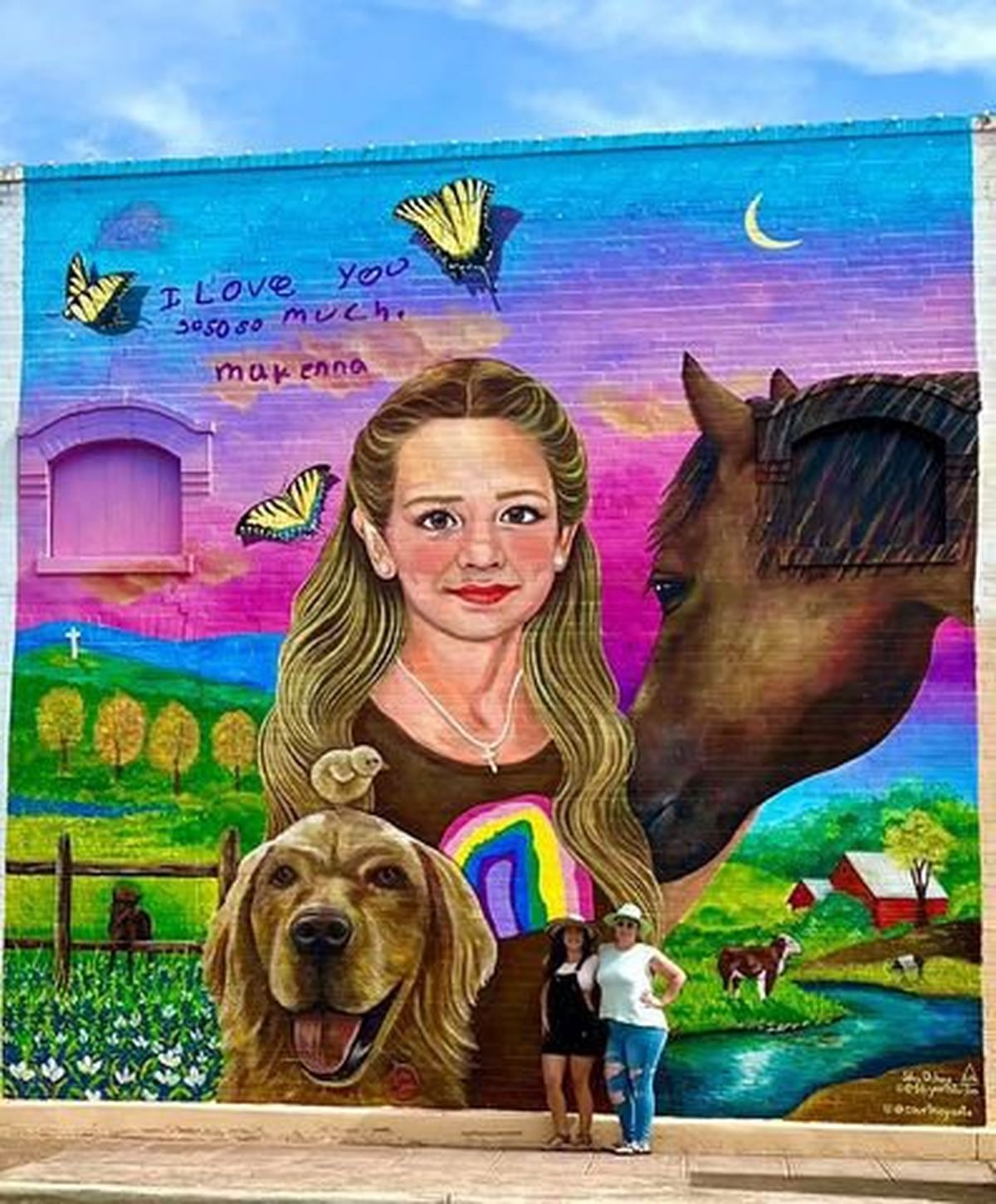 Artist Silvy Ochoa and her assignment partner pose in front of a mural in Uvalde, Texas, honoring 10-year-old Makenna Lee Elrod, who was among the 21 people killed by a gunman at Robb Elementary School in Uvalde in May. MUST CREDIT: Silvy Ochoa photo  (Silvy Ochoa/Handout)