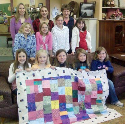 Girl Scout Troop 3014 made a quilt for the North Idaho Violence Prevention Center in Coeur d’Alene. The Athol troop includes: Amanda Curry, Kaylie Higbee, Alexys Howard, Hanne Larsen, Tehya Russell, Madison Salois, Shelby Salois, Sophia Thulin, Hannah Ziegler and (not pictured) Cynthia Gregg, Emma Heigel, Jaelyn Hennig, Keyonna Smith, Amanda Stevens and Cena Westphal. Back row: Girl Scout leader, Tanya Ziegler and parent helper Shan Salois, and NIVPC volunteer coordinator, Tamarah Cardwell.