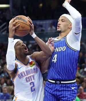 Magic guard Jalen Suggs defends Thunder guard Shai Gilgeous-Alexander on March 17 at the Kia Center in Orlando, Fla. (Tribune News Service)