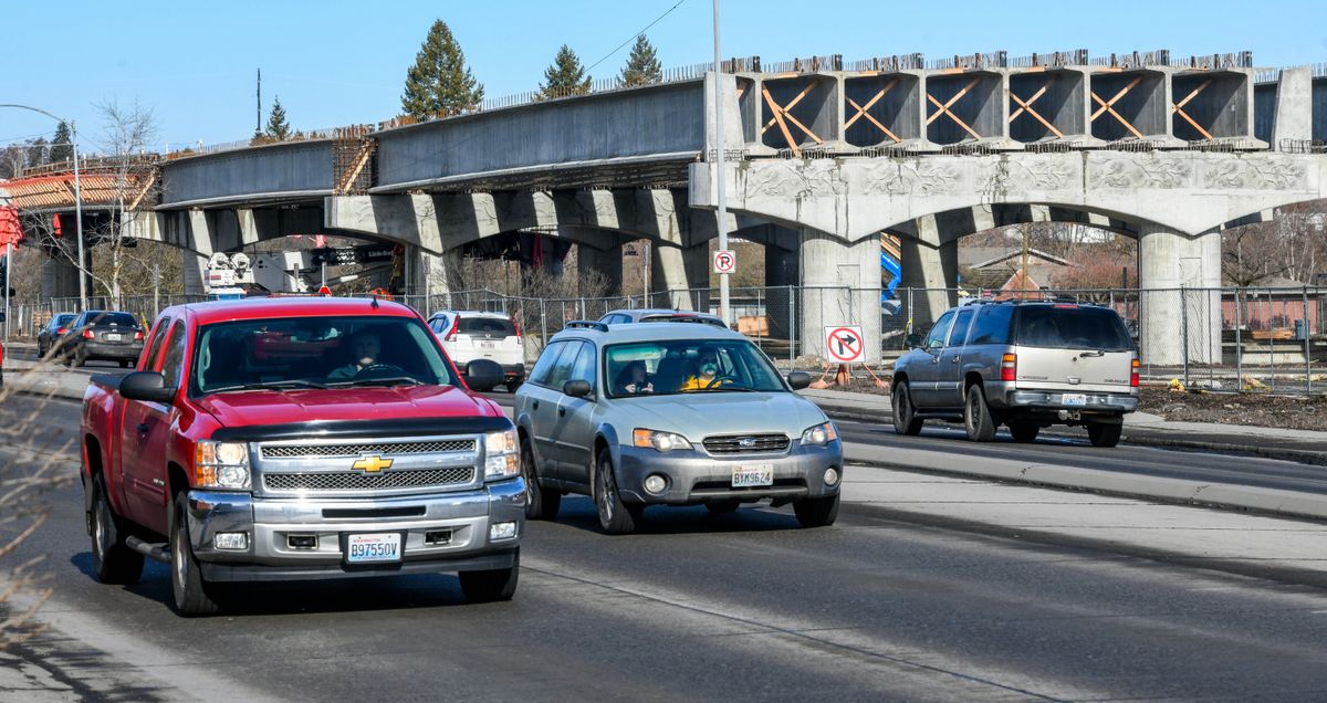 Traffic streams south on Greene Street past the North Spokane Corridor project rising from the Spokane Community College parking lot in February 2022.  (Dan Pelle/THE SPOKESMAN-REVIEW)