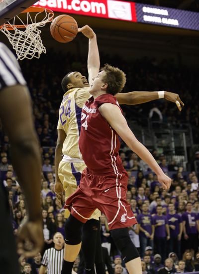 Washington State forward Josh Hawkinson, right, shoots the ball as Washington's Robert Upshaw defends during the first half of last Saturday's game in Seattle won by the Cougars. (Associated Press)