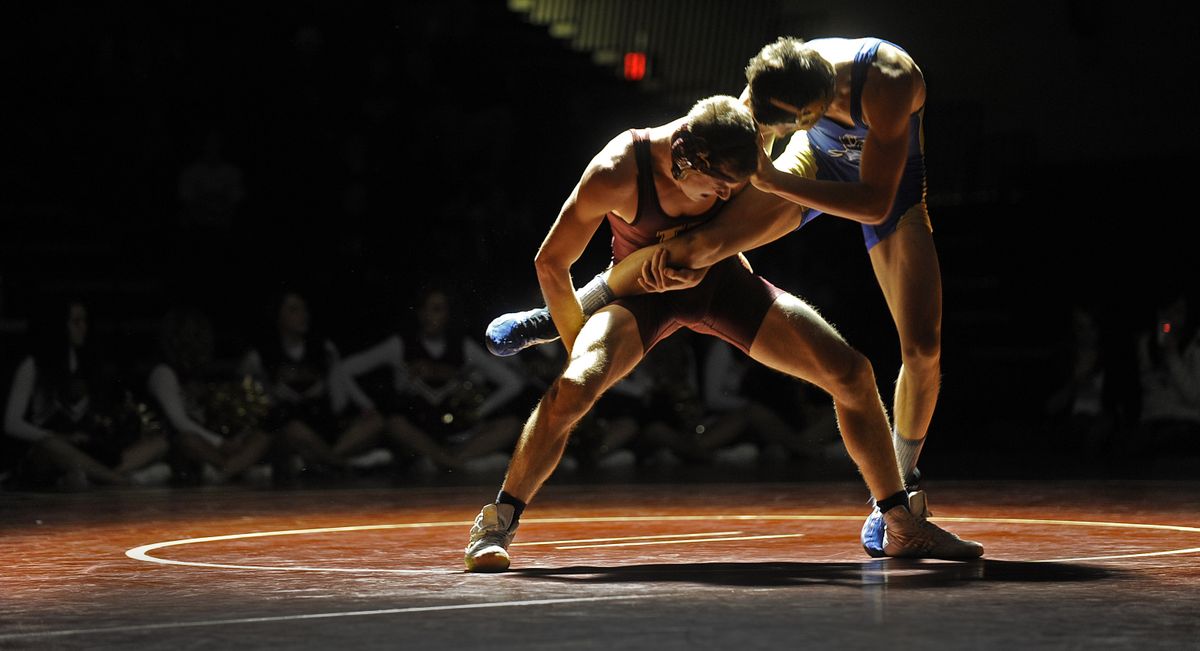 Trevin Hiebert of University, left, controls the leg of Jasen Jorgensen of Deer Park. (Christopher Anderson)