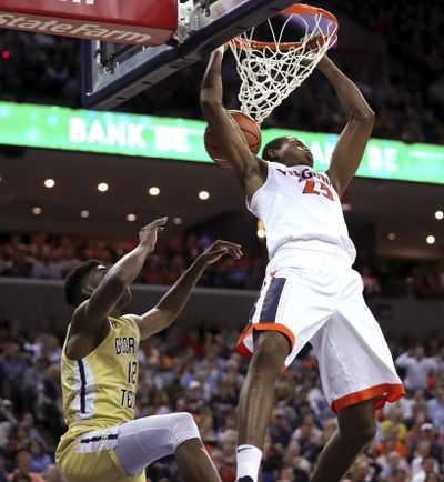 Virginia’s Nigel Johnson (23) dunks over Georgia Tech’s Moses Wright (12) during the second half of an NCAA college basketball game Wednesday, Feb. 21, 2018, in Charlottesville, Va. (Zach Wajsgras / Daily Progress via AP)