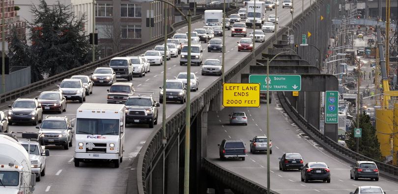 Northbound traffic backs-up on the upper deck of the Alaskan Way Viaduct, left, as southbound vehicles enter the lower deck, in downtown Seattle on Dec. 8, 2014.  (AP Photo/Elaine Thompson)