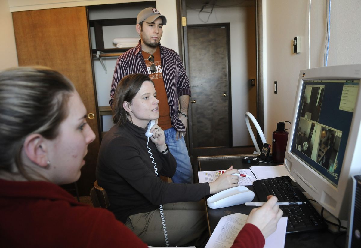 WSU undergraduate Carolyn Parsey, left, and graduate students Adri Seelye  and Chad Sanders observe on a monitor as Ashley Donnell proceeds with a memory test at the “smart apartment.” (Dan Pelle / The Spokesman-Review)