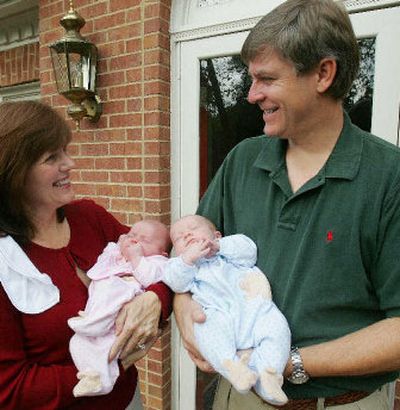 
Ted Farmer holds Henry and his wife Kim holds Grace as they get some air in front of their Alpharetta, Ga., home last week. Kim Farmer and other mothers of preemies complain of the difficulties of finding products ranging from small-sized clothes that can accommodate wires from life-support machines, to tiny bottles, to fortified formula
 (Associated Press / The Spokesman-Review)
