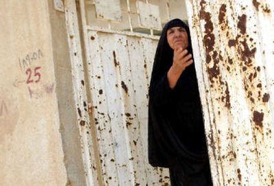 
Mother and wife to victims of Saddam Hussein, Khamisa Youssef points to where the 1982 attempt on Hussein's life took place in this July 18, 2005, file photo, in Dujail, north of Baghdad. For more than 20 years, Youssef has been dreaming of the day when Saddam would be brought to justice for having her husband and six sons killed along with 150 others in retaliation for a bold assassination attempt staged by the villagers at the height of Saddam's power. 
 (File/Associated Press / The Spokesman-Review)