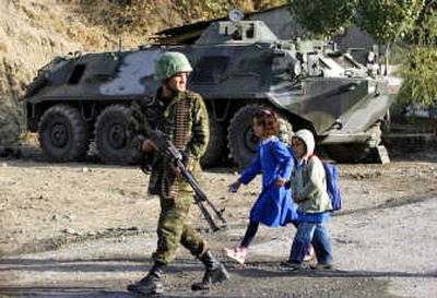 
Schoolchildren walk past  a Turkish soldier in  Sirnak on the Turkish-Iraqi border Monday. Associated Press
 (Associated Press / The Spokesman-Review)