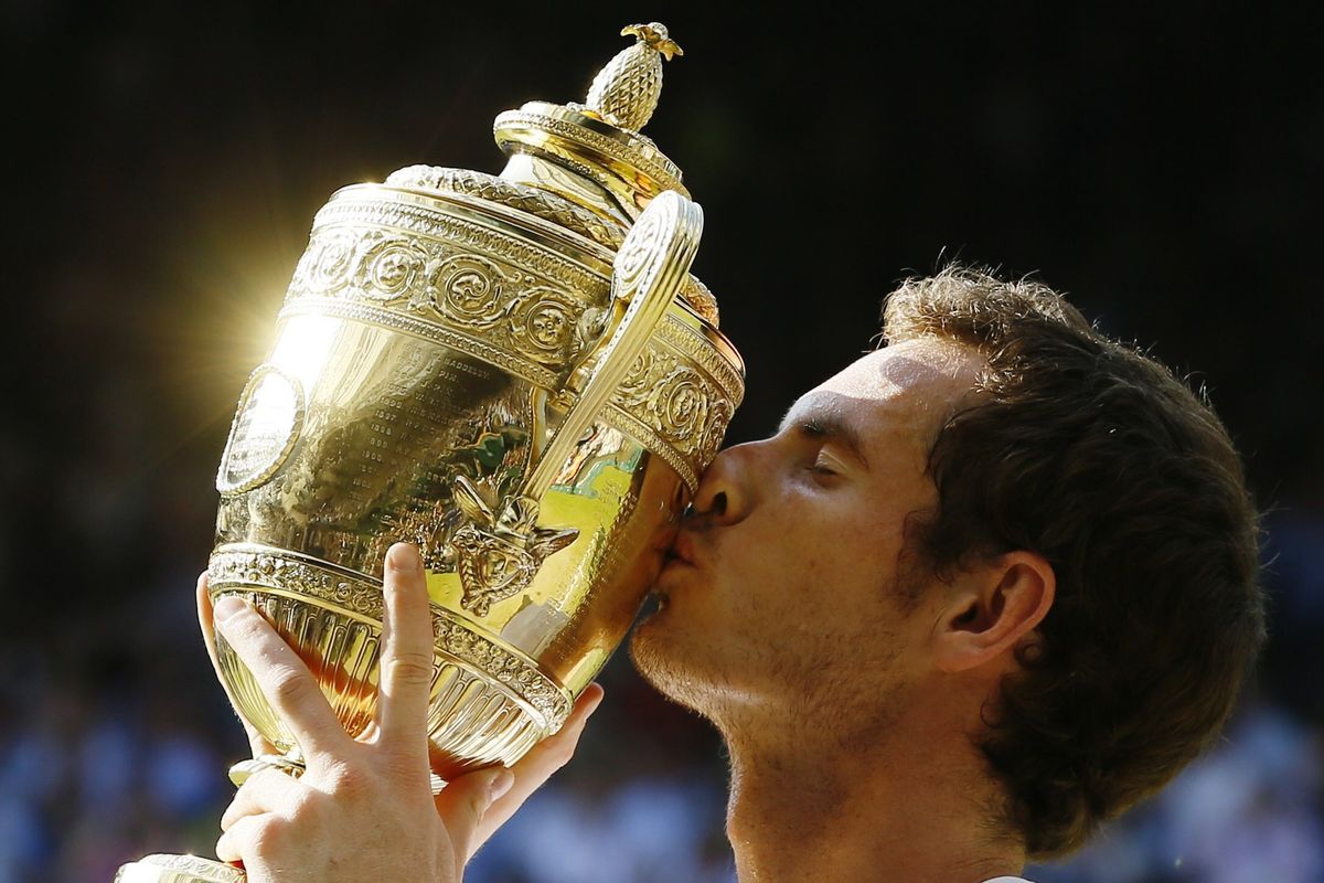 FILE - Andy Murray of Britain poses with the trophy after defeating Novak Djokovic of Serbia during the men