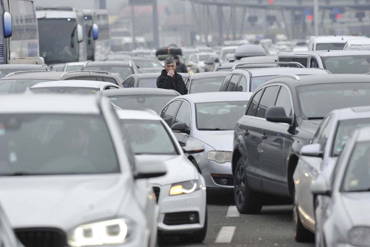 Motorists wait to cross the Croatian border from Slovenia, at Bregana border crossing, western Croatia, Saturday, Dec. 19, 2020. Balkan citizens going home from Western Europe for holidays have created huge traffic jams at border crossings despite coronavirus restrictions meant to discourage travel for Christmas and the New Year. Huge lines of cars have formed on the borders between Slovenia and Croatia as well as Hungary and Serbia as thousands of people waited for hours Saturday to cross.  (STR)