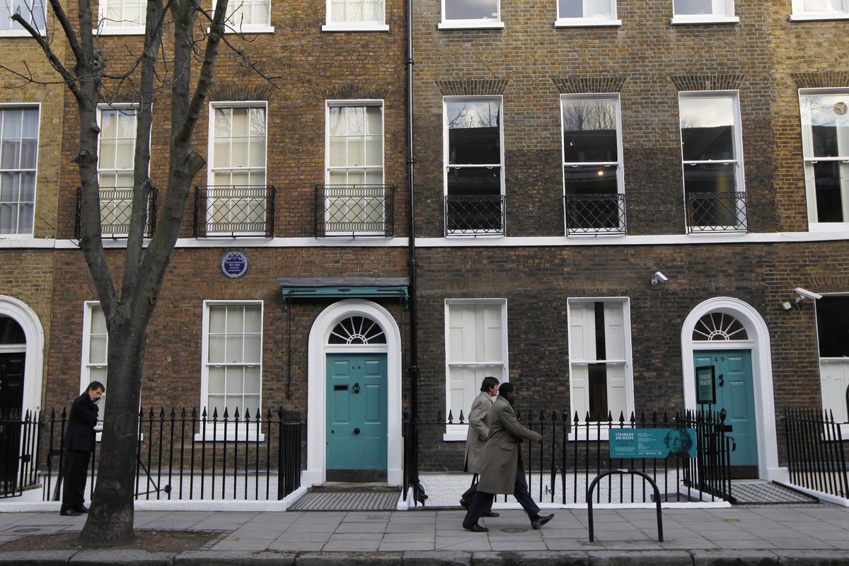 People walk past Charles Dickens’ home, left, part of the Charles Dickens Museum in London. (Associated Press)