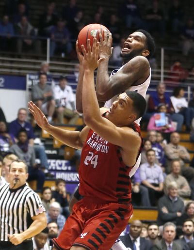 Northwestern’s Vic Law drives to the basket over Eastern Washington's Jacob Wiley (24) during the second half of Monday’s game in Evanston, Illinois. (Charles Rex Arbogast / Associated Press)