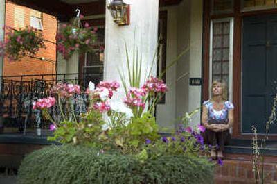 
Diana Stephenson takes in the view from the front steps of her Browne's Addition apartment complex. Stephenson recently moved from a house, and enjoys the freedom from yardwork and home upkeep.
 (Christopher Anderson/ / The Spokesman-Review)