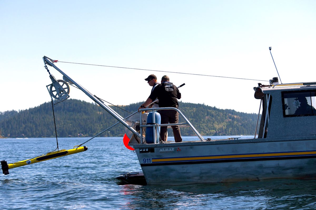 A sonar is lowered into Lake Coeur d’Alene from a Kootenai County Sheriff’s boat on Monday near the scene of an airplane crash that happened on Sunday.  (Kathy Plonka/The Spokesman-Review)