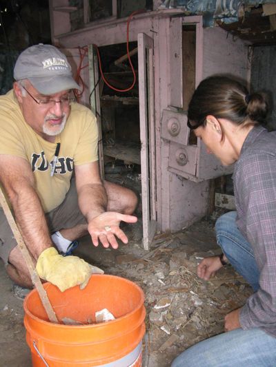 From left, University of Idaho professor Mark Warner, Rachel Reichert, UI graduate student Renae Campbell, and architect Byron Folwell confer as an archaeological survey begins on the James Castle homesite. At far left, Scott May walks out of the tiny bunkhouse where, for years, Castle lived and worked. (Betsy Russell / The Spokesman-Review)