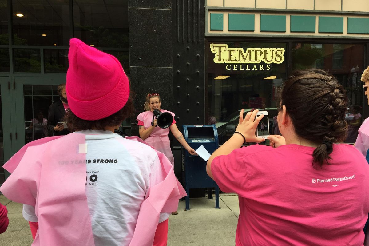 Beth Robinette speaks to Planned Parenthood supporters through a bullhorn outside the downtown Spokane office of Rep. Cathy McMorris Rodgers on Thursday, June 1, 2017. Robinette said efforts by lawmakers to restrict funding to the nonprofit shut off access to “basic health care” to others like her. (Kip Hill / The Spokesman-Review)