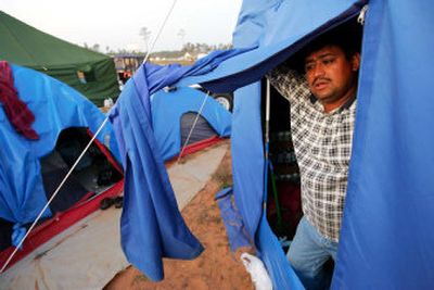 
Above: Lazaro Sandoval speaks from his tent at a makeshift camp for immigrant workers cleaning up after Hurricane Katrina in Ocean Springs, Miss. 
 (The Spokesman-Review)