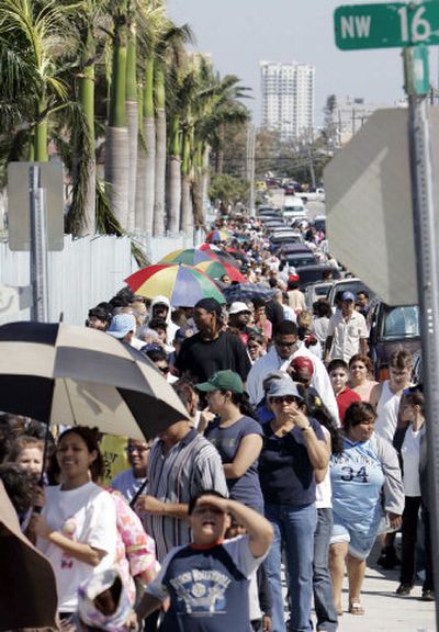 
Residents wait for water and ice being handed out by the city of Miami Tuesday. View a multimedia slideshow of photos from Florida and Cuba at spokesmanreview.com/blogs/video
 (Associated Press / The Spokesman-Review)