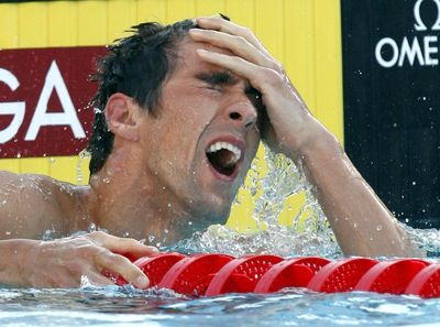 Michael Phelps reacts after winning gold in 200-meter butterfly. (Associated Press / The Spokesman-Review)