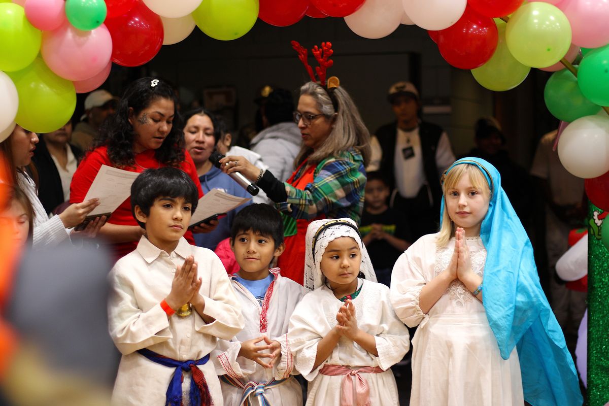 Children portraying the Virgin Mary and Joseph stand near the entrance of the West Central Community Center to kick off Latinos en Spokane’s La Posada event Saturday evening.  (Monica Carrillo-Casas/The Spokesman-Review)
