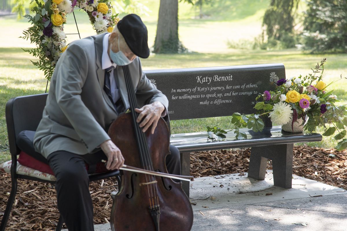 Dr. Bill Wharton, professor emeritus of the cello at the University of Idaho, plays a somber melody in front of the park bench placed in the green space in front of the University of Idaho administration building, shown Sunday, Aug. 22, 2021, the tenth anniversary of her death. Benoit was a cellist and longtime student of Wharton’s. She died after being shot by a UI psychology professor in 2011. The professor, Ernesto Bustamante, then killed himself.  (Jesse Tinsley/THE SPOKESMAN-REVIEW)
