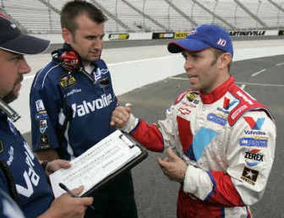 
Scott Riggs, right, talks to car chief Rodney Childers, center, and engineer Tim Turner, left, after winning pole. 
 (Associated Press / The Spokesman-Review)