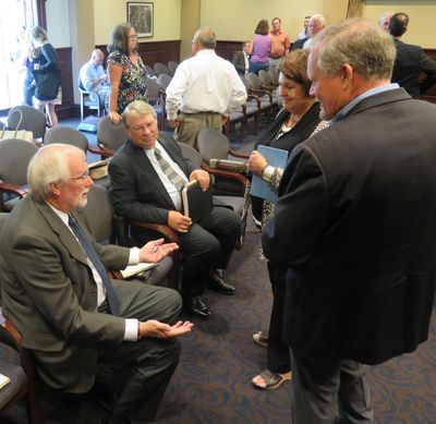 Idaho Secretary of State Lawerence Denney, seated at center, talks campaign finance reform with, from right, Sens. Marv Hagedorn and Patti Anne Lodge and Chief Deputy Secretary of State Tim Hurst, during a break in a legislative hearing on Wednesday, July 12, 2017, at the Idaho state Capitol. (Betsy Z. Russell)