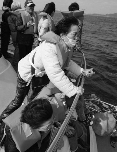 
Tourists eagerly scan for whales at a whale watching point off Okinawa, southwestern Japan, on Thursday. 
 (Associated Press / The Spokesman-Review)