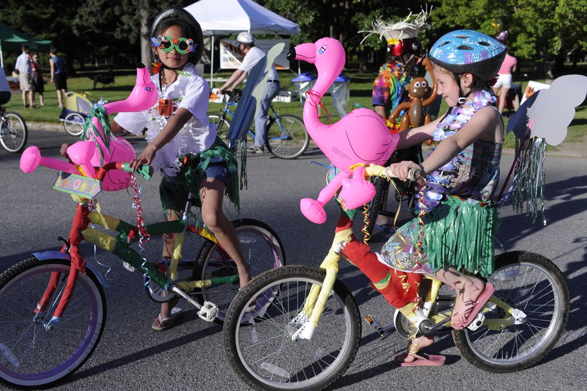 Amaya Martin, 9, left, Jacob Lawrence, 10, (in back) and Jose Lawrence, 7, spent the day decorating themselves and their bikes in a slash of Hawaiian color for the Spokane Summer Parkways event in 2016. (Colin Mulvany / The Spokesman-Review)