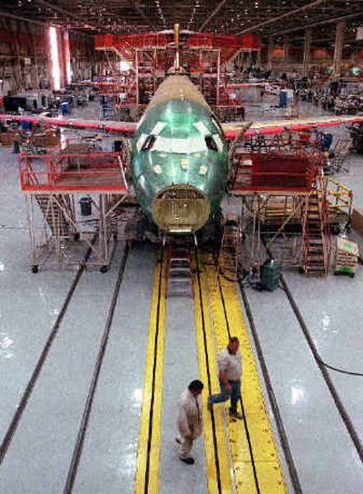 
A new Boeing 717 aircraft is shown while being built on a moving assembly line at Boeing's Long Beach, Calif., plant in 2000. Boeing Co. said Friday it will end production of the 717 jet, its smallest passenger plane, next year, and plans to charge $615 million against earnings before taxes related to that and the loss of a $23 billion deal to supply refueling tankers to the U.S. Air Force. 
 (Associated Press / The Spokesman-Review)