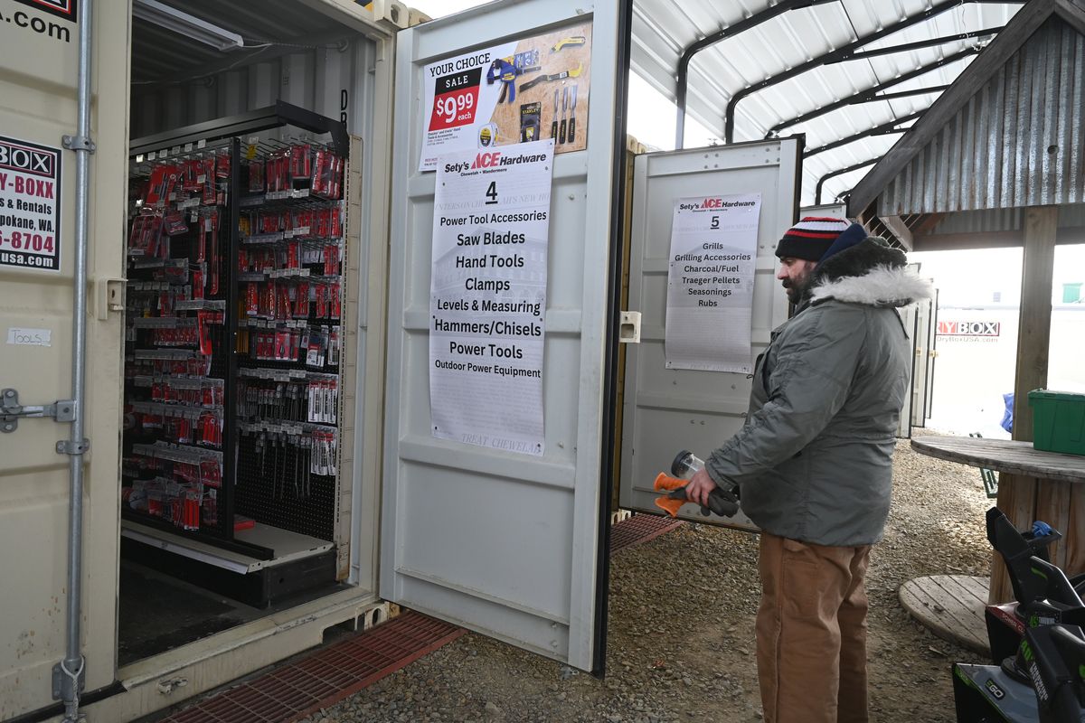 Paul Sety, proprietor of Sety’s Ace Hardware in Chewelah, Wash., shows how he moved his store into steel shipping containers after the store burned completely in August. The temporary store, on the land where the store once had a garden center, will stay active until a new building can be built inside the shell of the historic building where it once stood.  (Jesse Tinsley/THE SPOKESMAN-REVIEW)