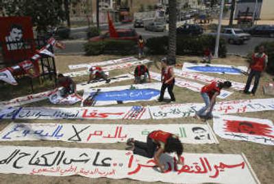 
Lebanese activists  prepare banners for celebration after the Israeli government approved a  deal to swap prisoners with Hezbollah in  Sidon, Lebanon, on Sunday. Associated Press
 (Associated Press / The Spokesman-Review)
