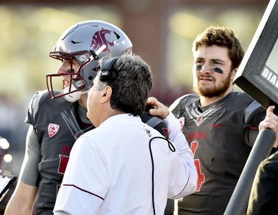 Washington State Cougars head coach Mike Leach gives pointers to Washington State Cougars quarterback Tyler Hilinski (3) during the second half of a college football game on Saturday, Oct 15, 2016, at Martin Stadium in Pullman. (Tyler Tjomsland / The Spokesman-Review)
